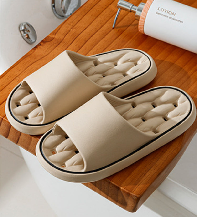 Beige open-toe slide slippers with thick sole and molded cushioned footbed.