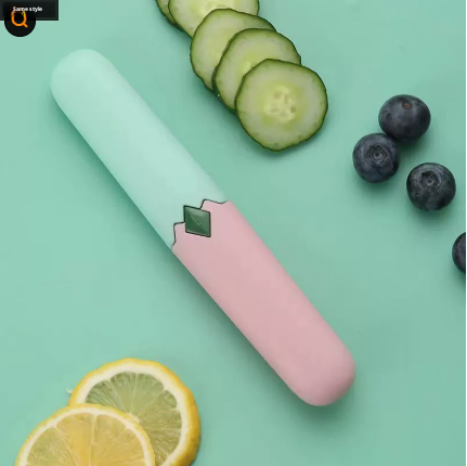 Two-in-one fruit knife with white handle and pink sleeve, green blade insert detail
